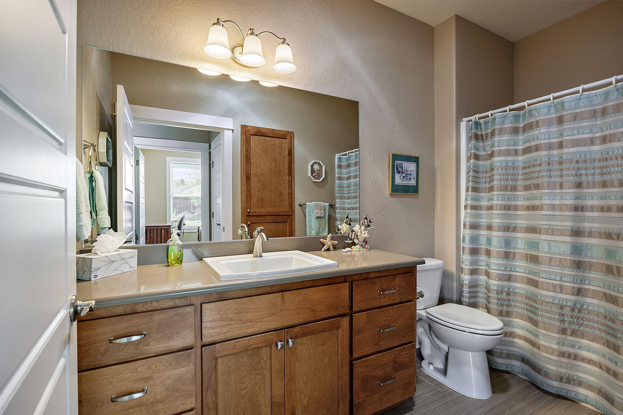 1128 Boulder Ridge Street Central Point, OR 97502 - Photo 15 of 33 a bathroom with a double vanity sink toilet mirror and shower