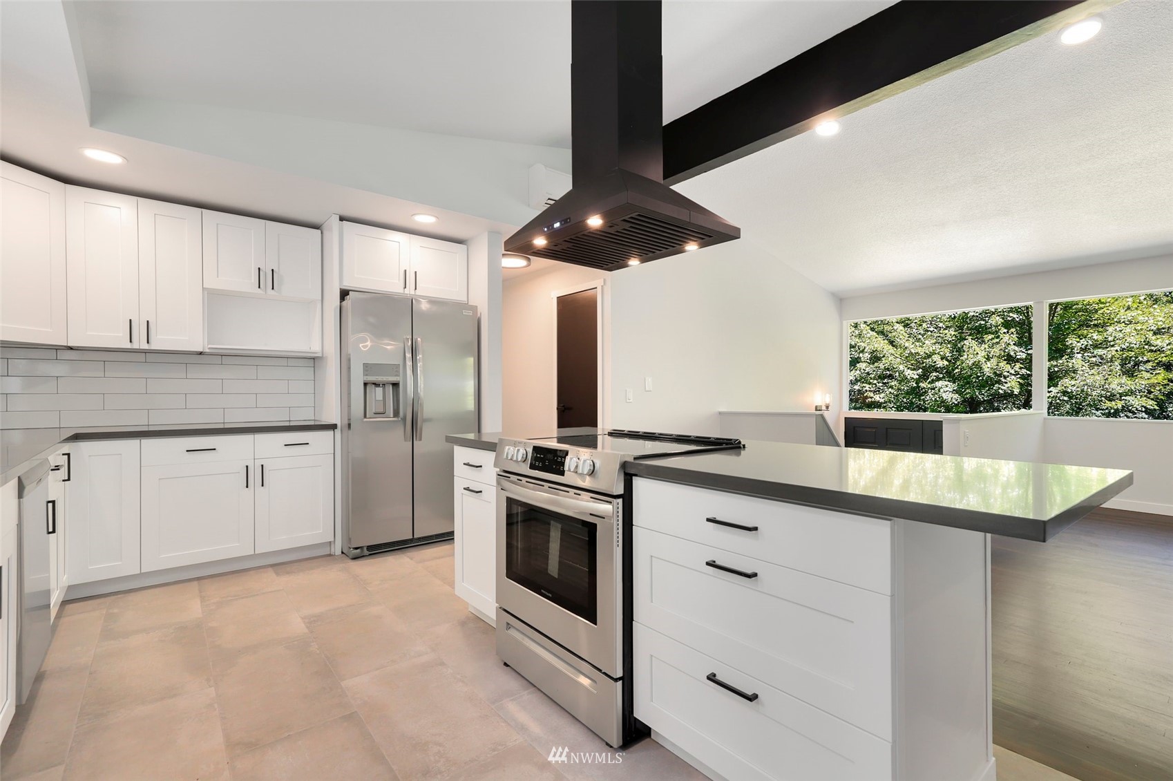 23314 25th Drive Southeast Bothell, WA 98021 - Photo 12 of 40 a kitchen with stainless steel appliances granite countertop a stove a sink and a refrigerator