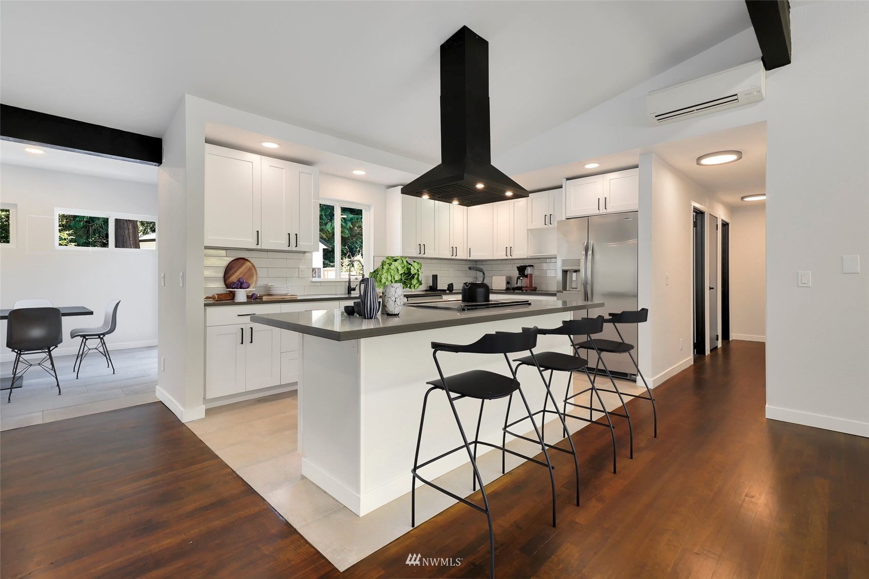 23314 25th Drive Southeast Bothell, WA 98021 - Photo 8 of 40 a kitchen with stainless steel appliances kitchen island a refrigerator a stove a sink a dining table and chairs with wooden floor