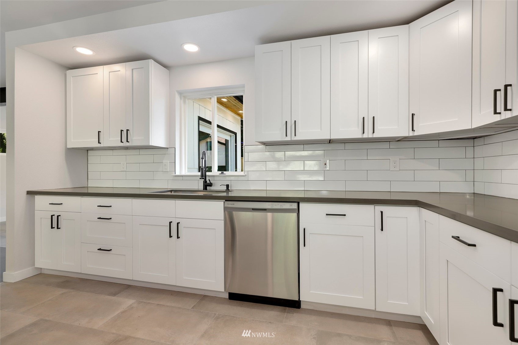 23314 25th Drive Southeast Bothell, WA 98021 - Photo 9 of 40 a kitchen with granite countertop white cabinets and a sink