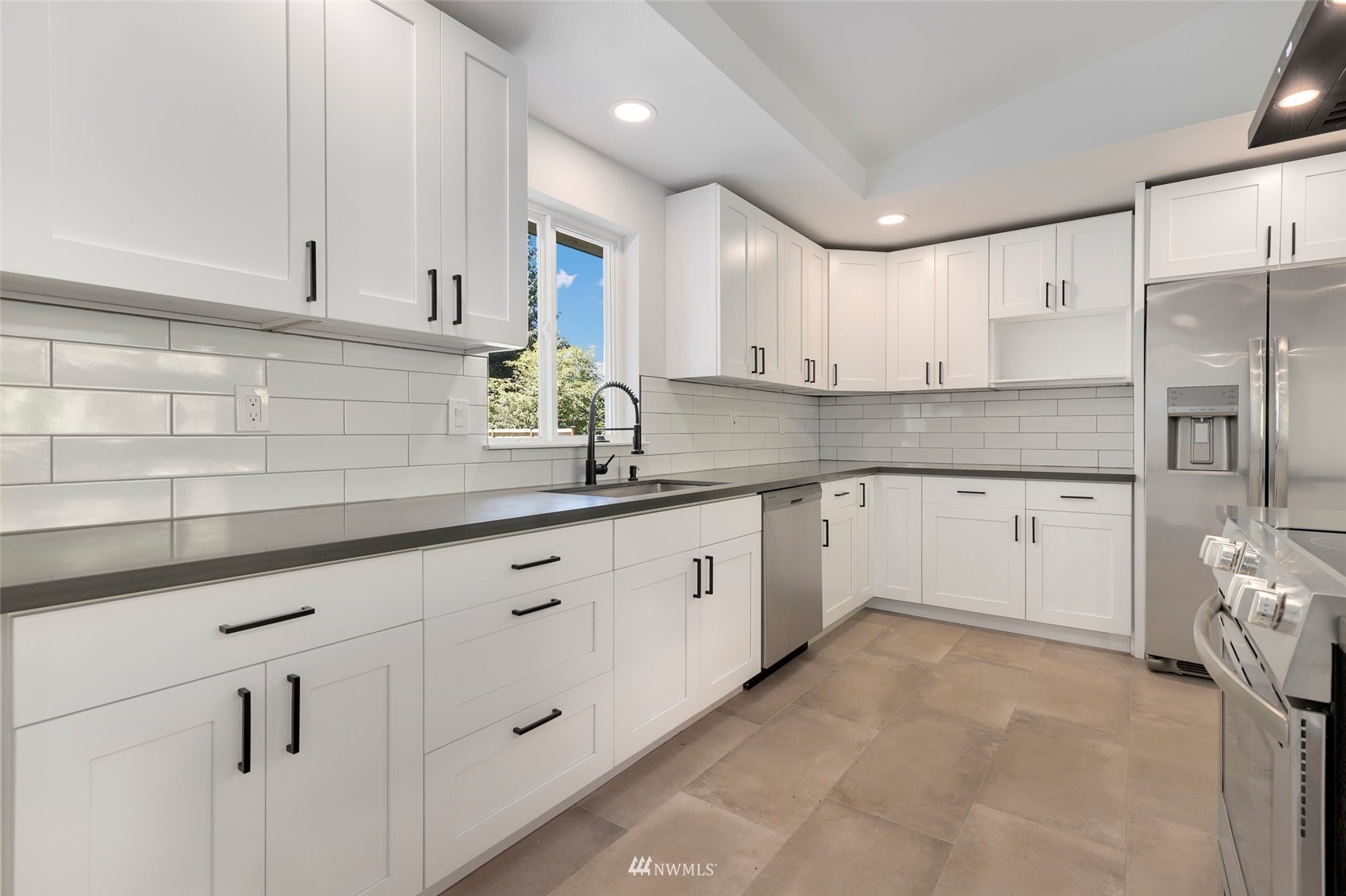 23314 25th Drive Southeast Bothell, WA 98021 - Photo 10 of 40 a kitchen with granite countertop white cabinets white stainless steel appliances with a sink and dishwasher