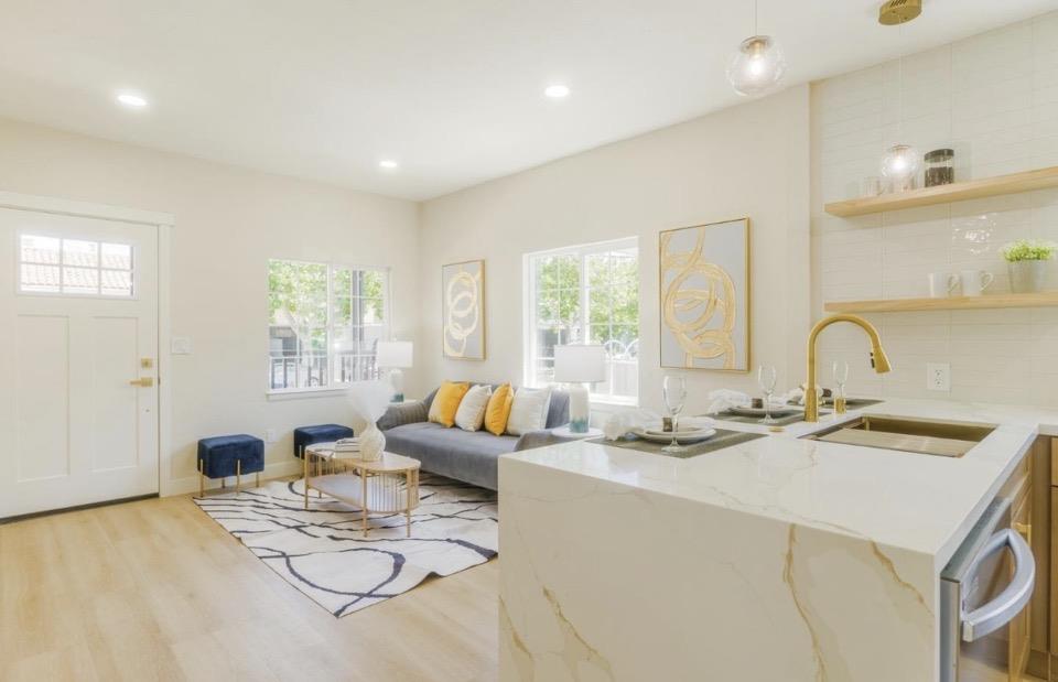 735 Locust Street San Jose, CA 95110 - Photo 9 of 21 a kitchen with a sink a stove a dining table and chairs