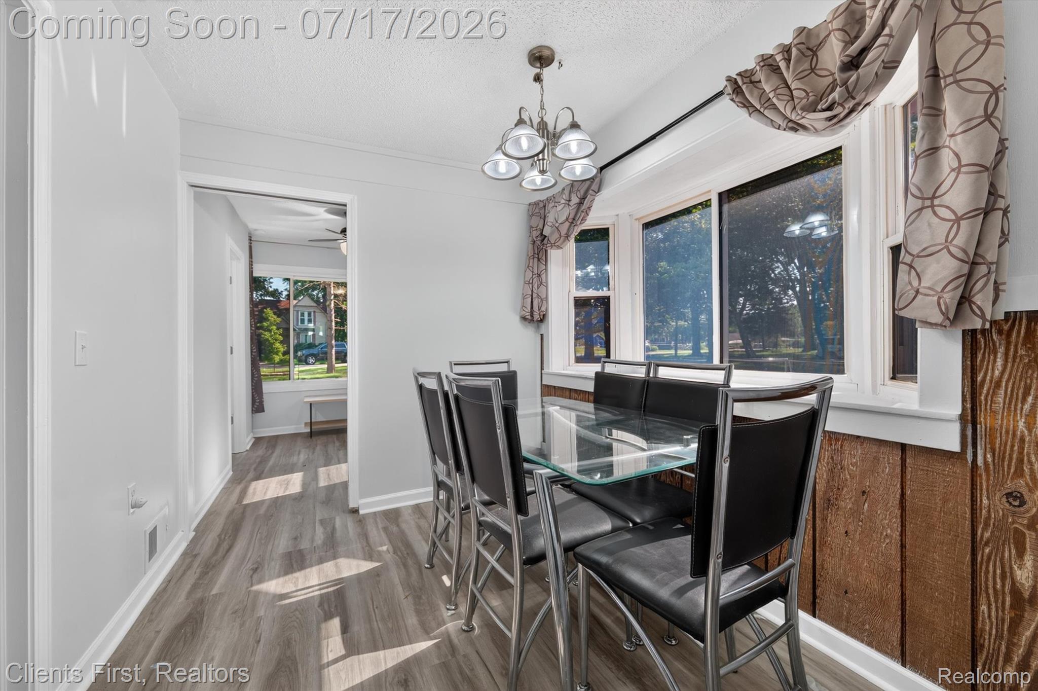 36852 Chase Street Romulus, MI 48174 - Photo 14 of 40 Dining area featuring wood-finish flooring, a multi-pane window, and a chandelier light fixture