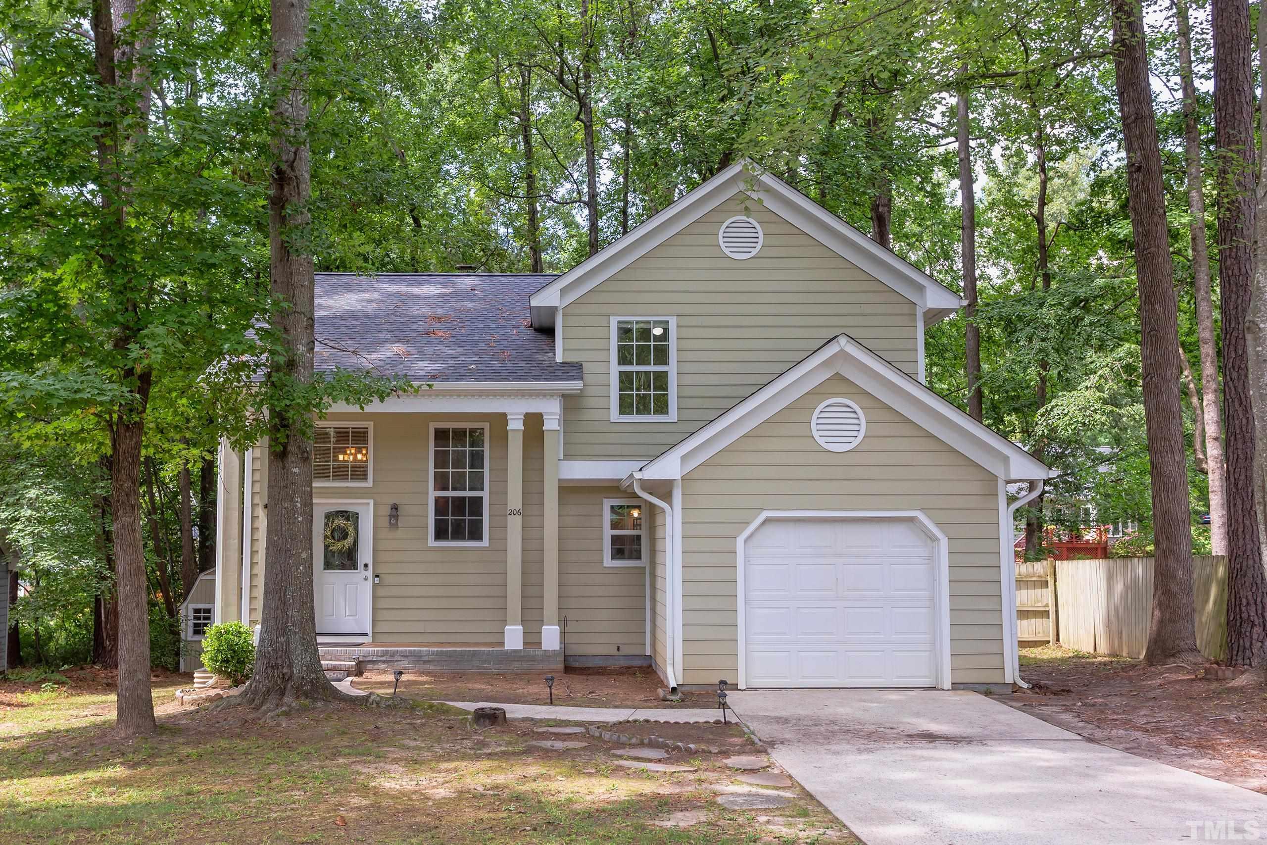 206 Eagle Tavern Drive Garner, NC 27529 - Photo 1 of 41 a front view of a house with a yard and garage