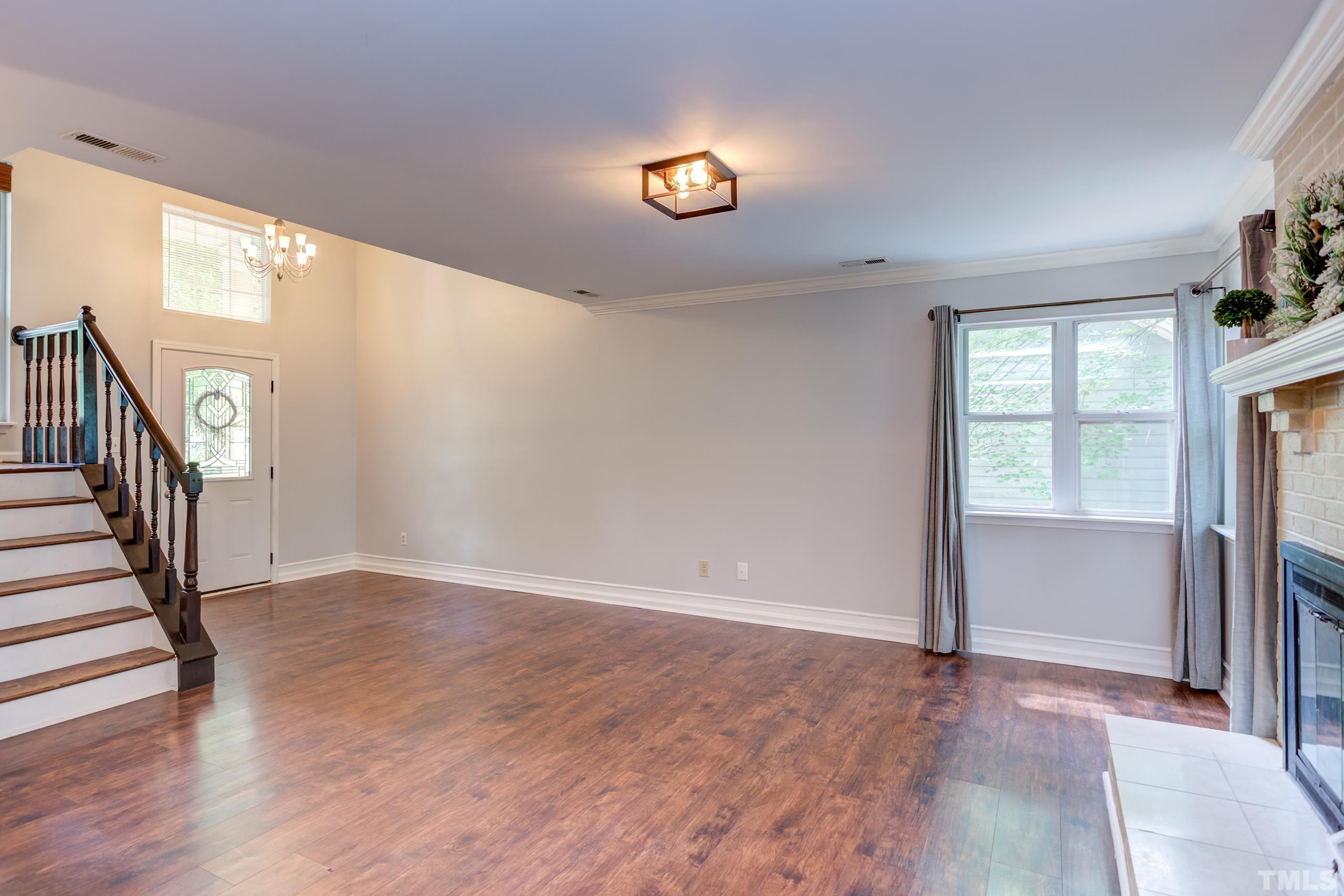 206 Eagle Tavern Drive Garner, NC 27529 - Photo 15 of 41 wooden floor in an empty room with a window