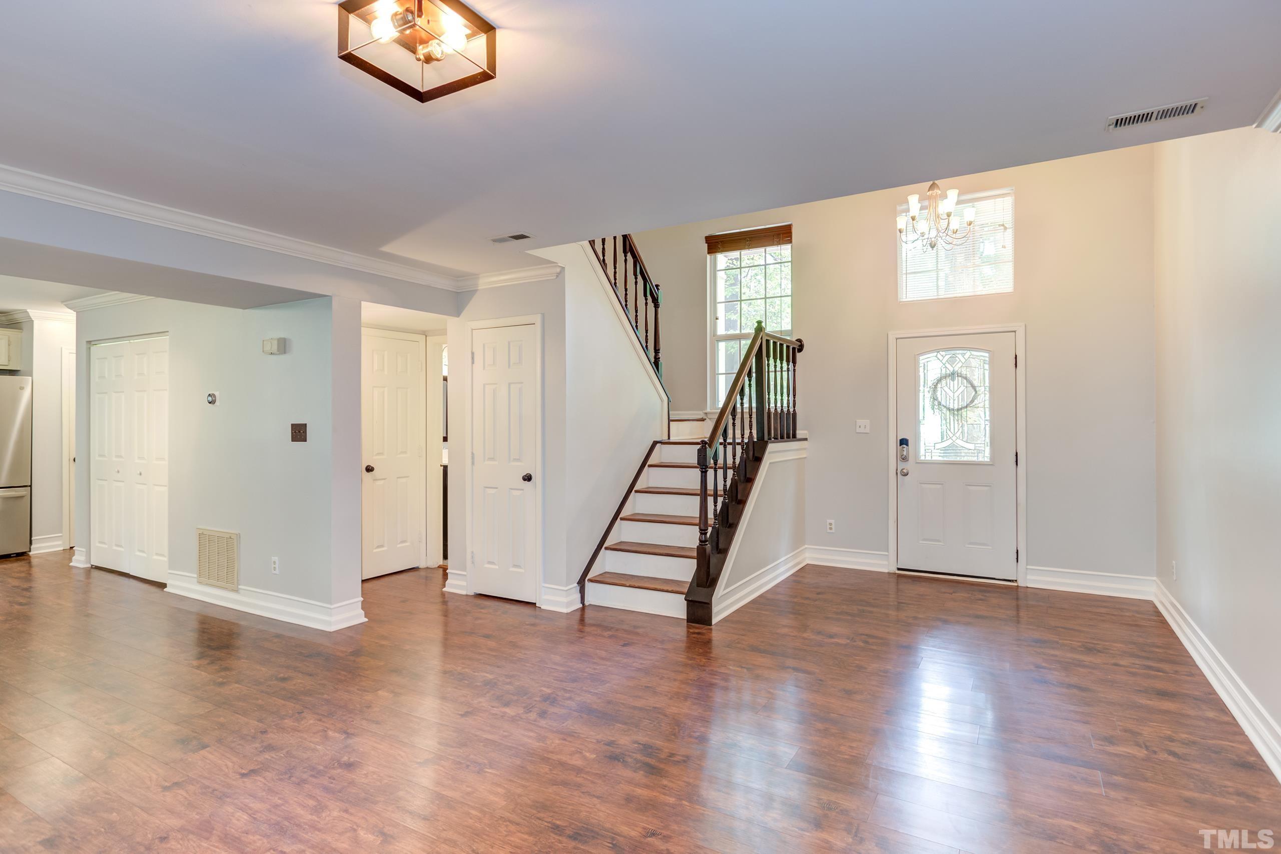 206 Eagle Tavern Drive Garner, NC 27529 - Photo 16 of 41 a view of an entryway with wooden floor and windows