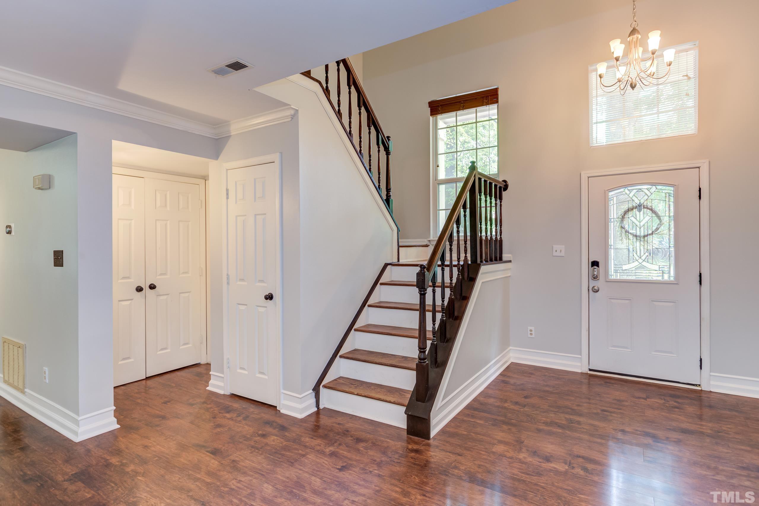 206 Eagle Tavern Drive Garner, NC 27529 - Photo 17 of 41 a view of entryway with wooden floor and stair