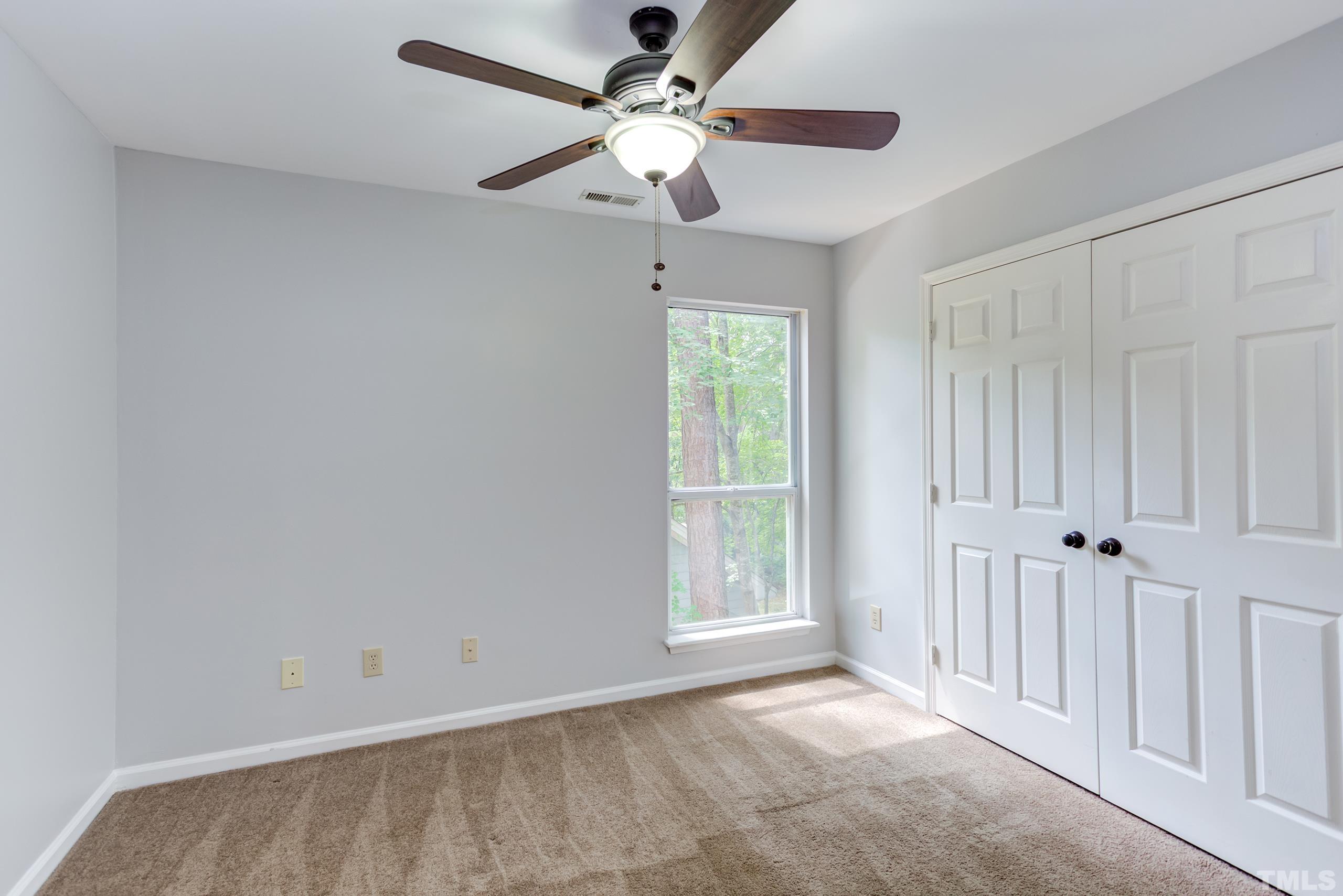 206 Eagle Tavern Drive Garner, NC 27529 - Photo 21 of 41 an empty room with windows and fan