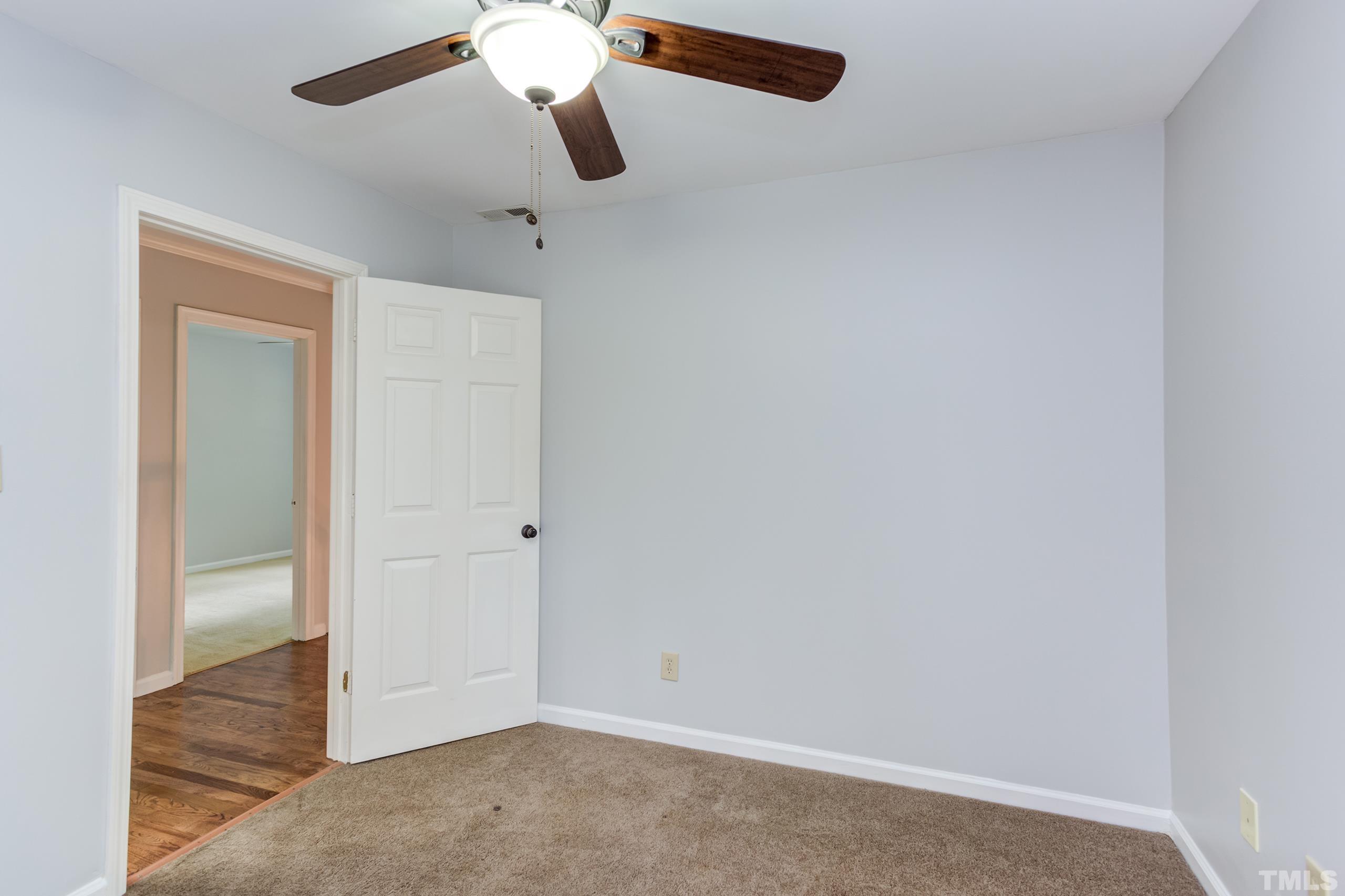 206 Eagle Tavern Drive Garner, NC 27529 - Photo 23 of 41 an empty room with closet and a chandelier fan