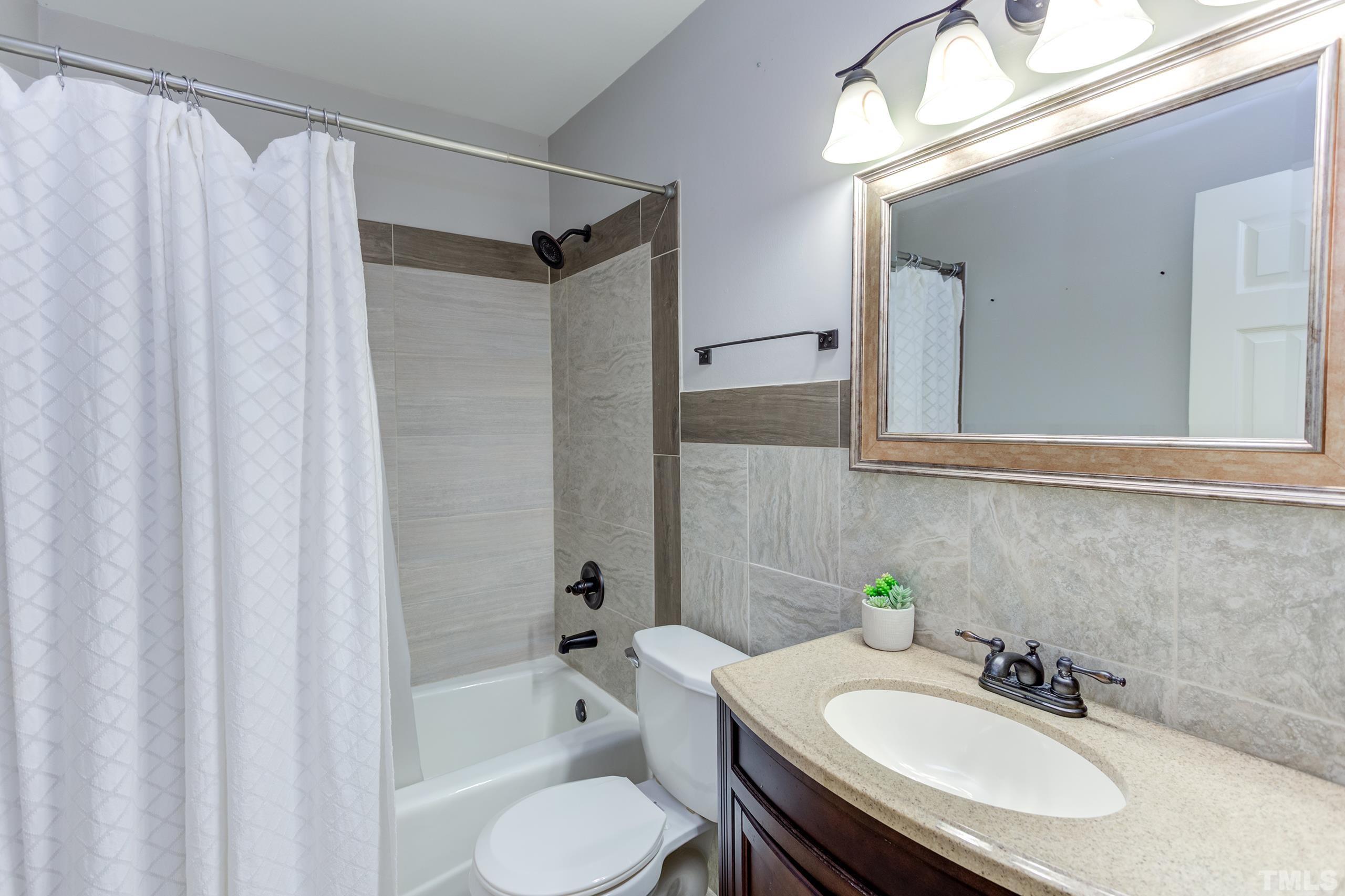 206 Eagle Tavern Drive Garner, NC 27529 - Photo 24 of 41 a bathroom with a sink toilet and shower