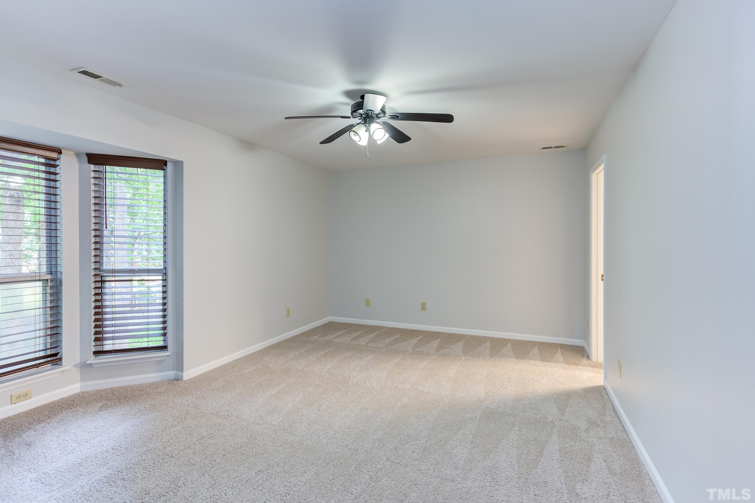 206 Eagle Tavern Drive Garner, NC 27529 - Photo 25 of 41 an empty room with windows and fan