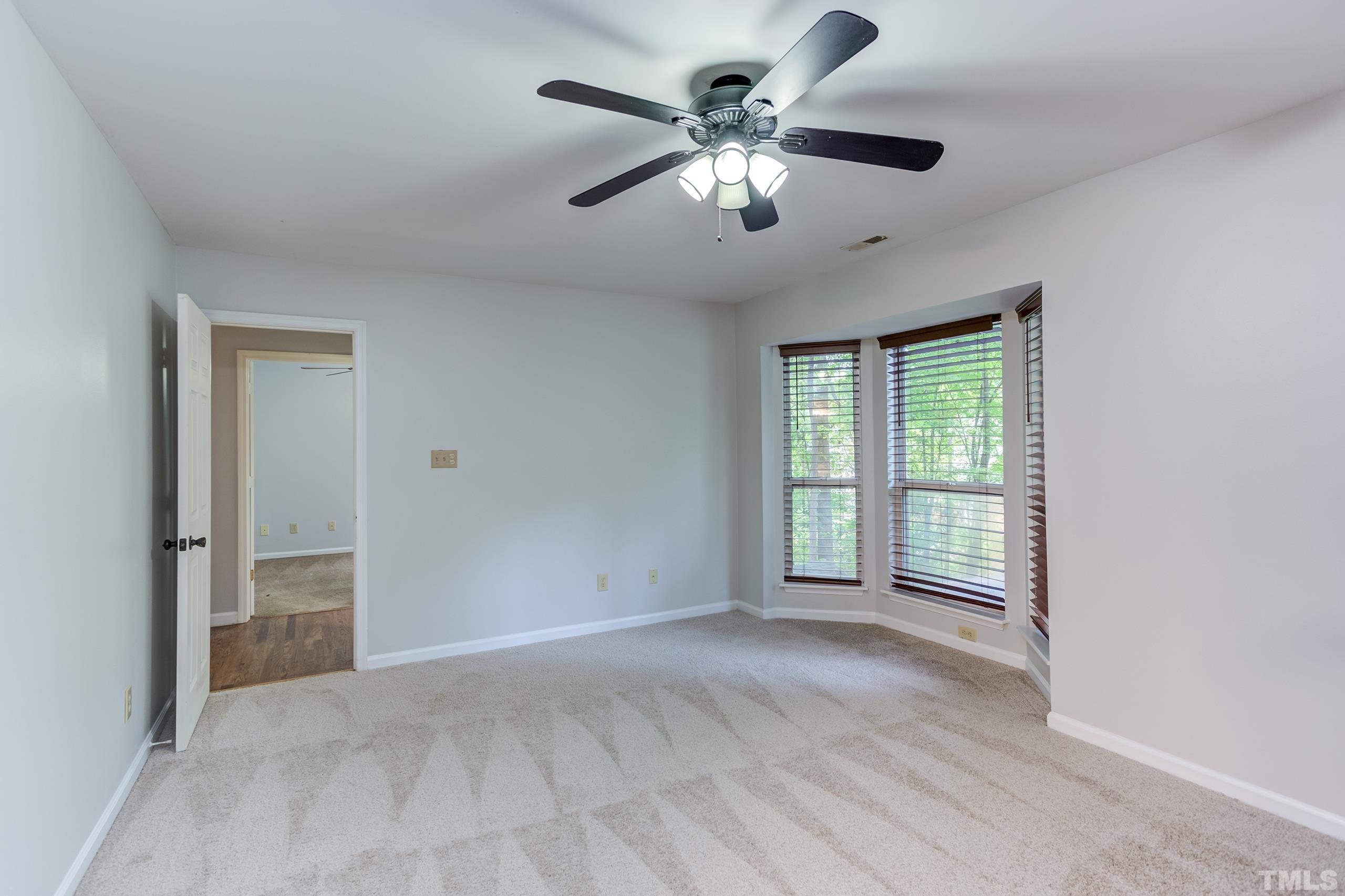 206 Eagle Tavern Drive Garner, NC 27529 - Photo 26 of 41 an empty room with chandelier fan and windows