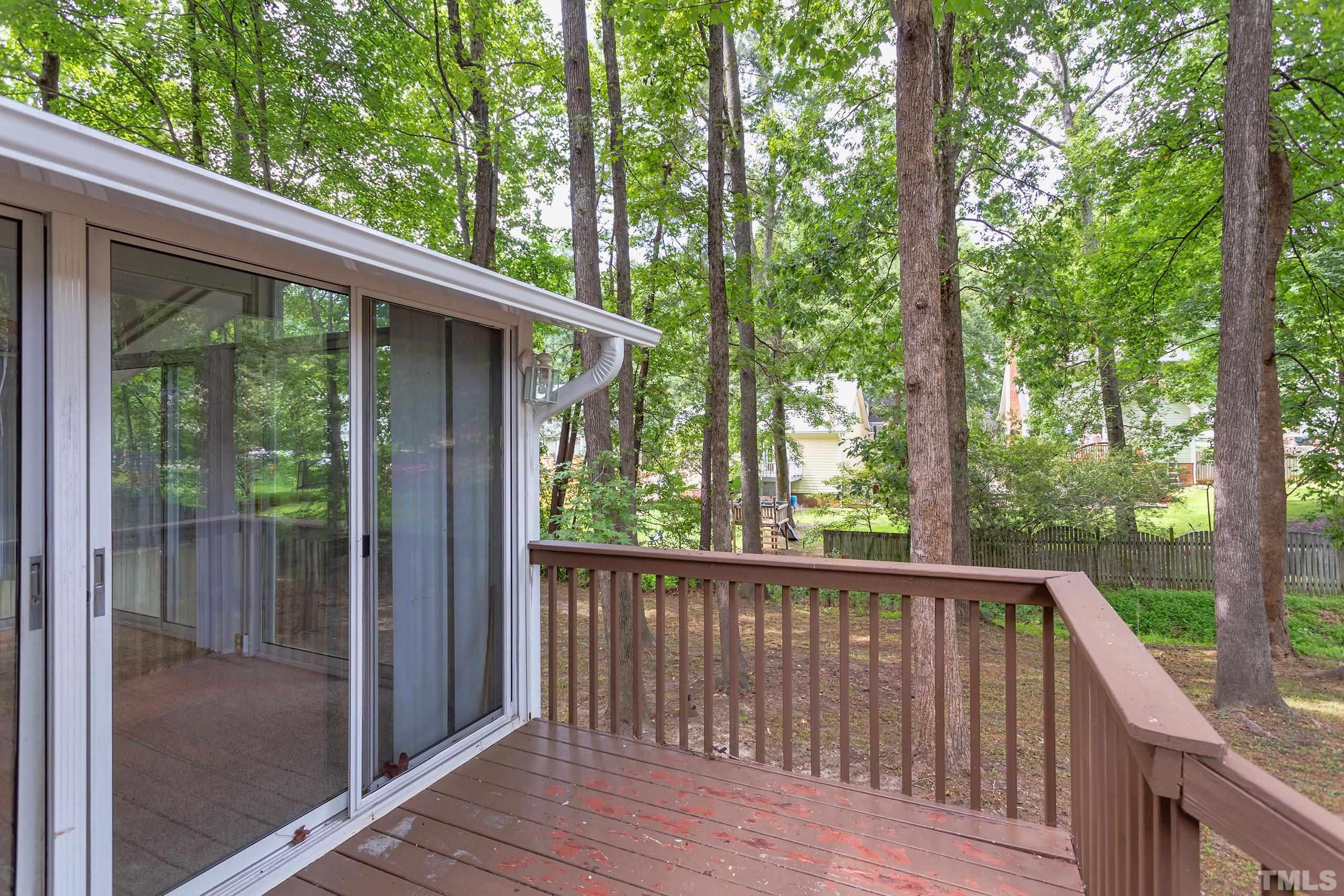 206 Eagle Tavern Drive Garner, NC 27529 - Photo 33 of 41 a view of a wooden deck next to a yard