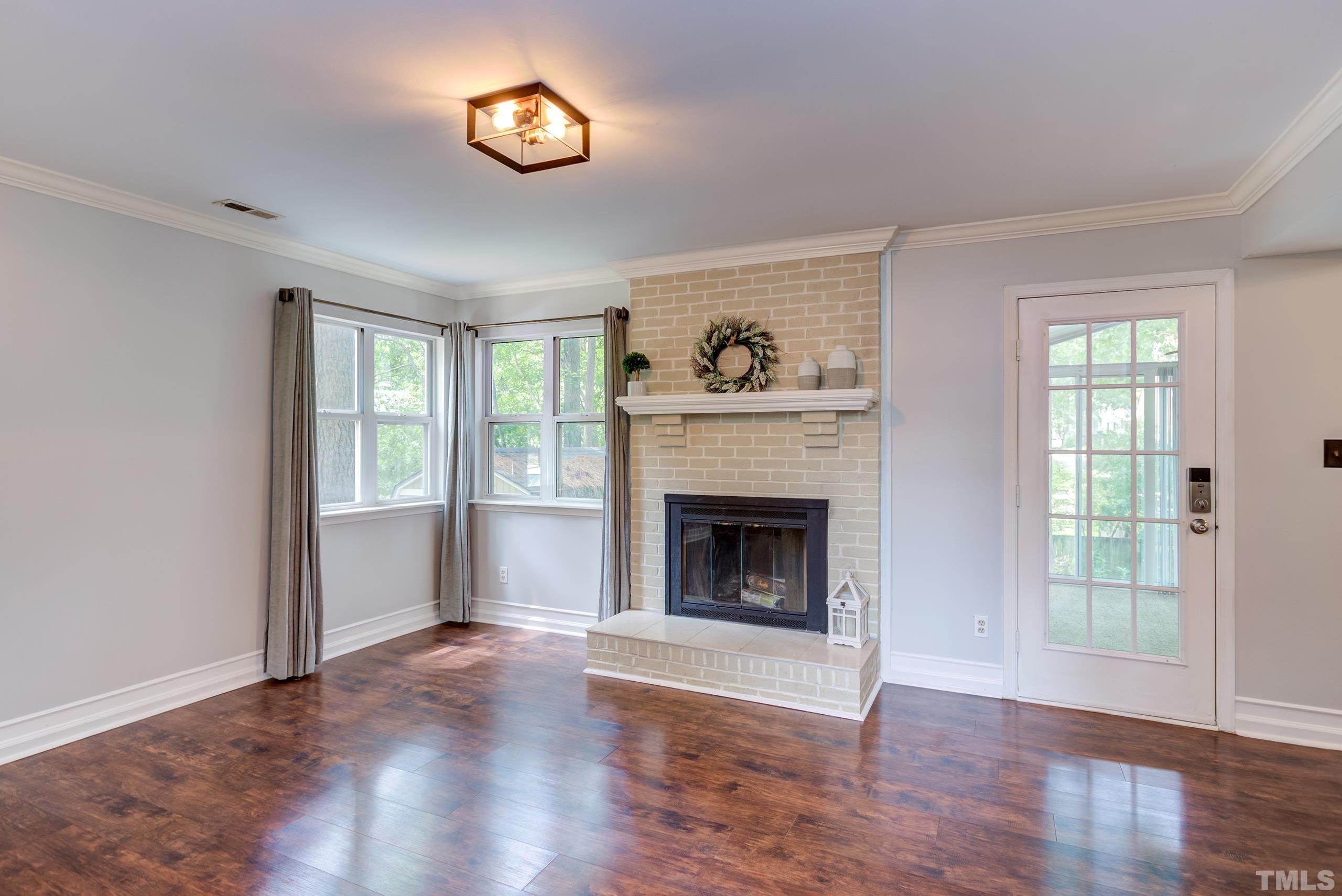 206 Eagle Tavern Drive Garner, NC 27529 - Photo 4 of 41 a living room with wooden floor and a fireplace
