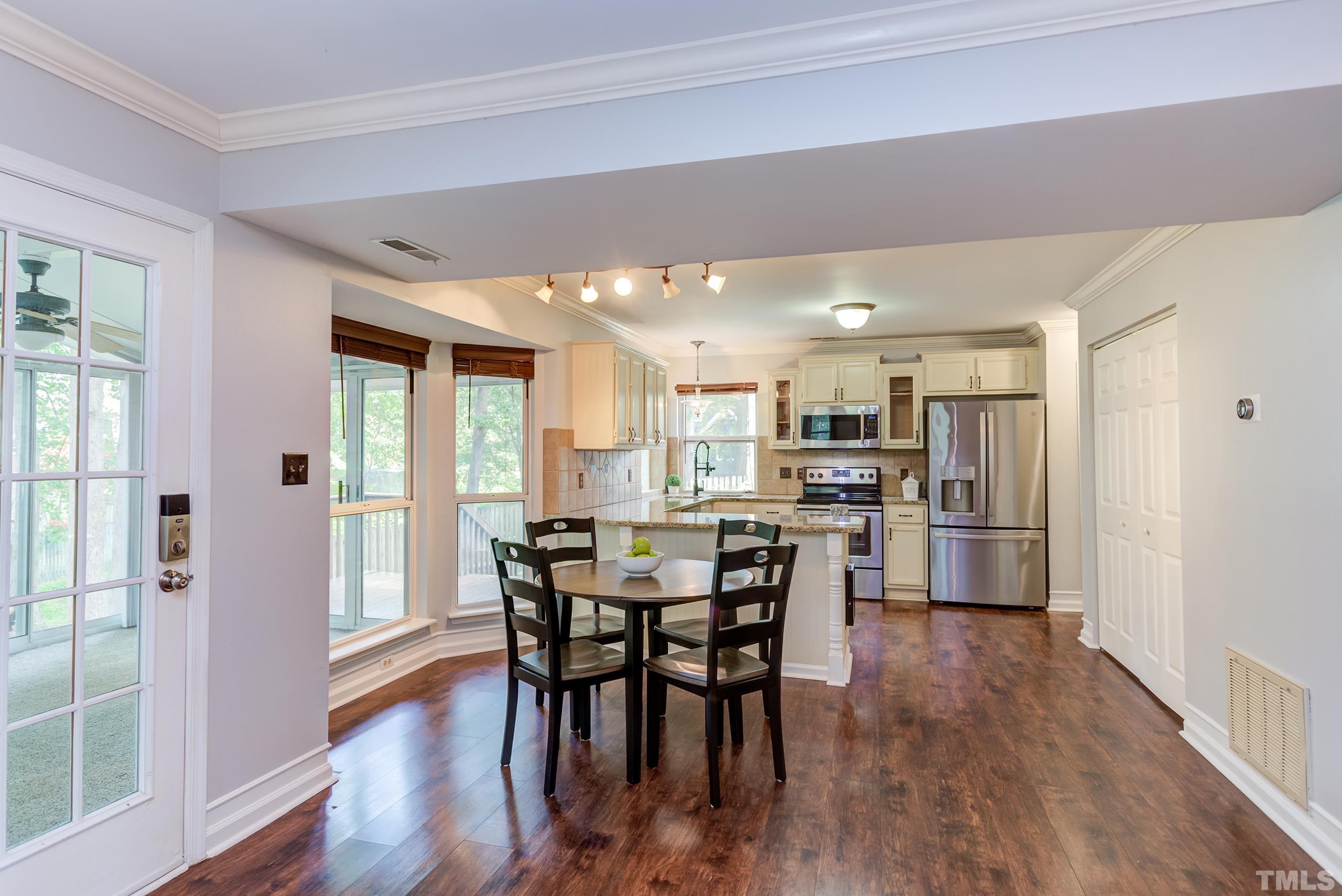 206 Eagle Tavern Drive Garner, NC 27529 - Photo 5 of 41 a view of a dining room with furniture and wooden floor