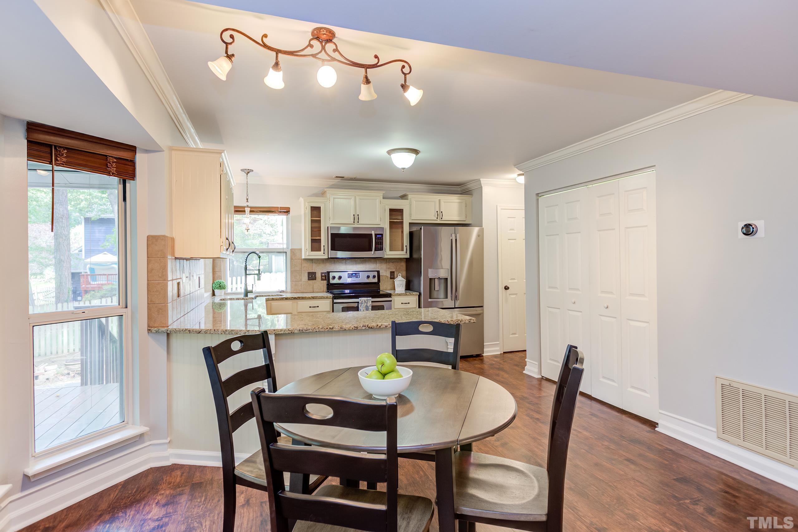 206 Eagle Tavern Drive Garner, NC 27529 - Photo 7 of 41 a view of a dining room with furniture and wooden floor