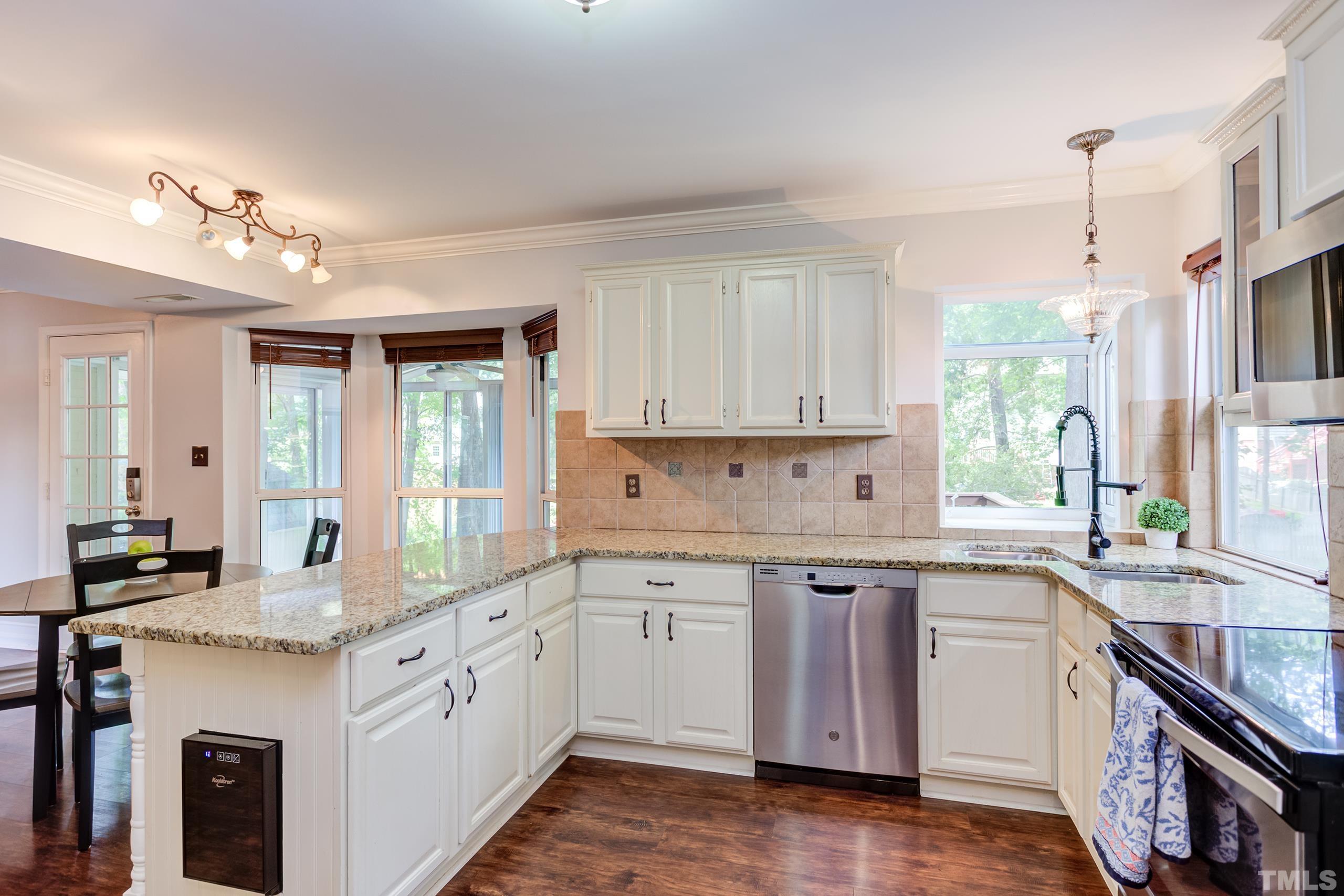 206 Eagle Tavern Drive Garner, NC 27529 - Photo 10 of 41 a kitchen with granite countertop white cabinets and white appliances