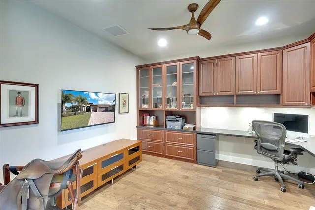 a living room with furniture cabinets and window