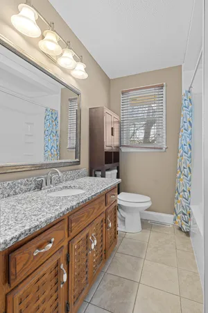 an empty room and chandelier fan