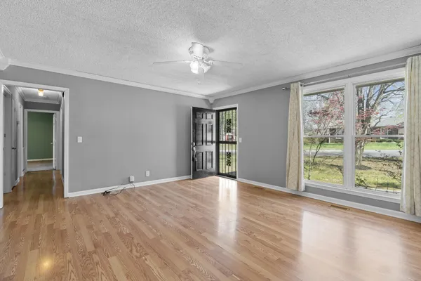 a view of an empty room with wooden floor