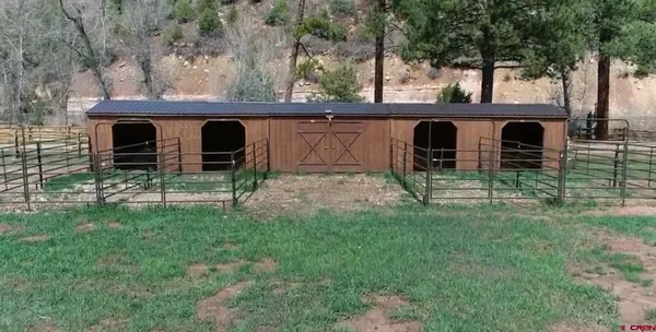 a view of backyard with wooden fence