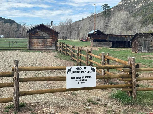 a view of outdoor space with green field and trees