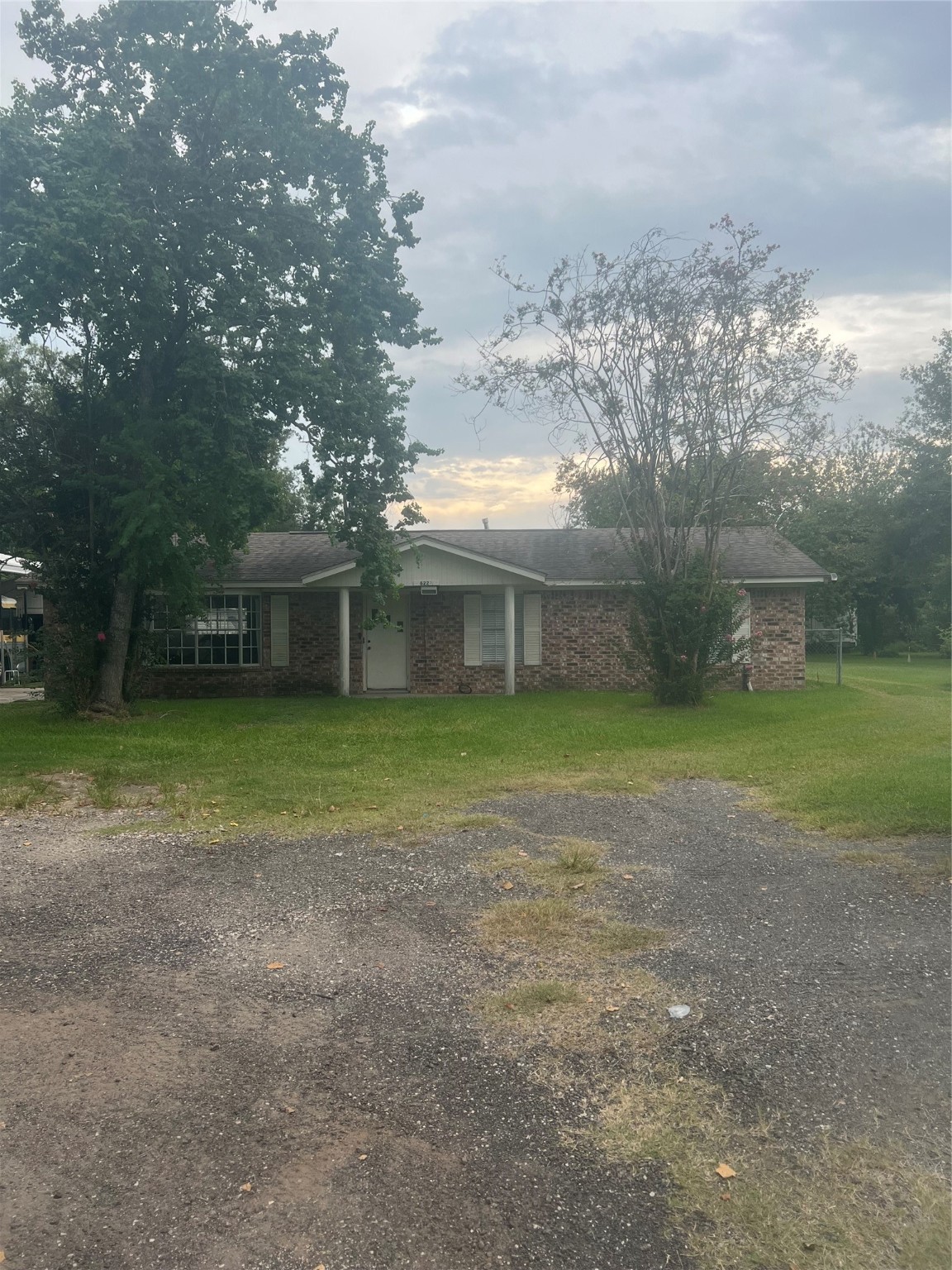 a view of a house with a yard and a tree