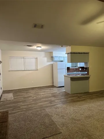a view of kitchen and refrigerator