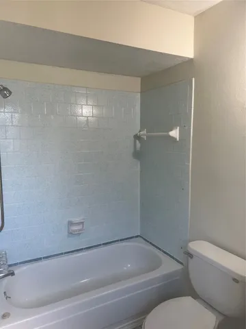 a bathroom with a toilet and bathtub