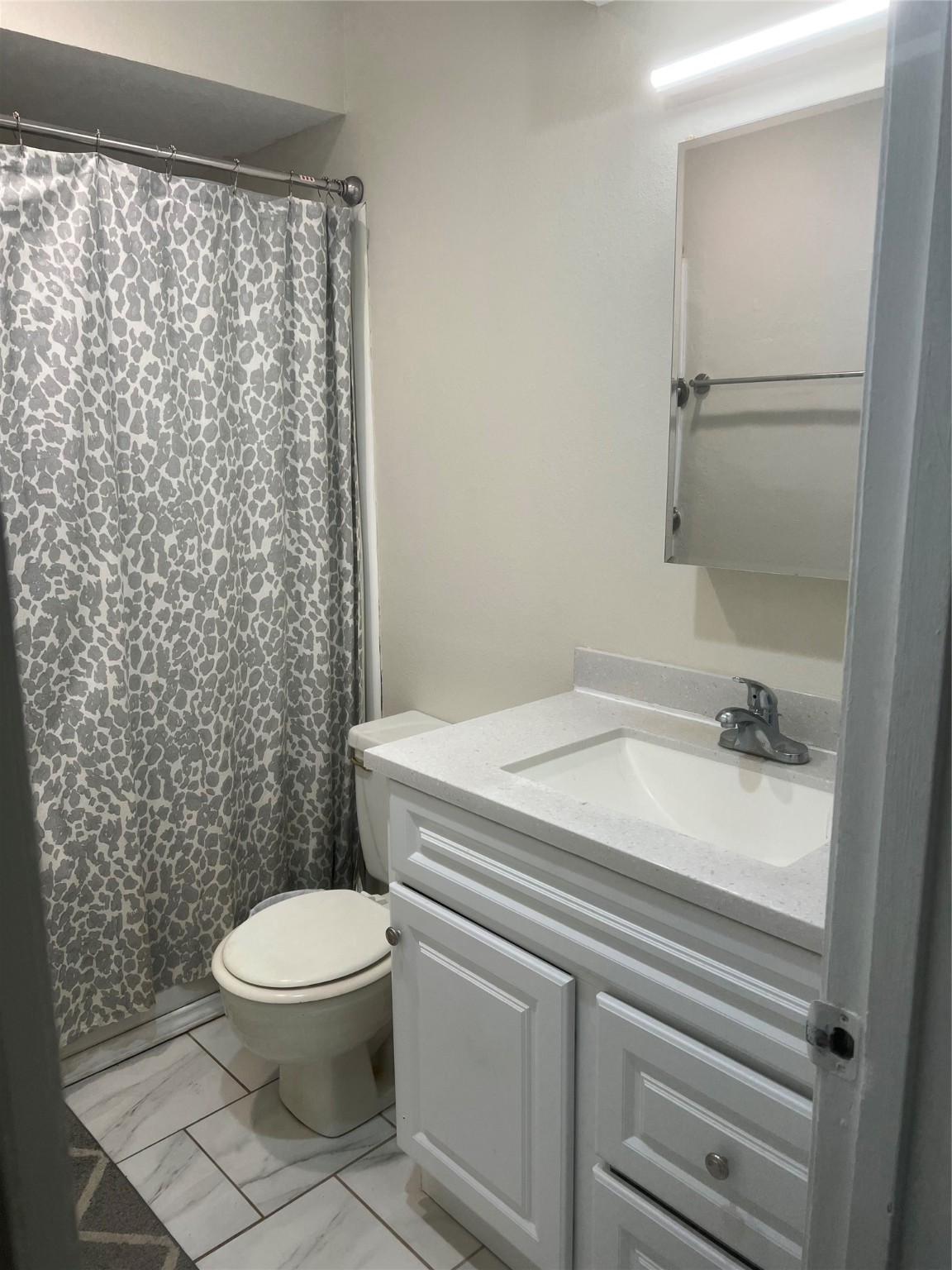 622 1/2 Coolidge Street Channelview, TX 77530 - Photo 10 of 10 a bathroom with a granite countertop toilet and a shower