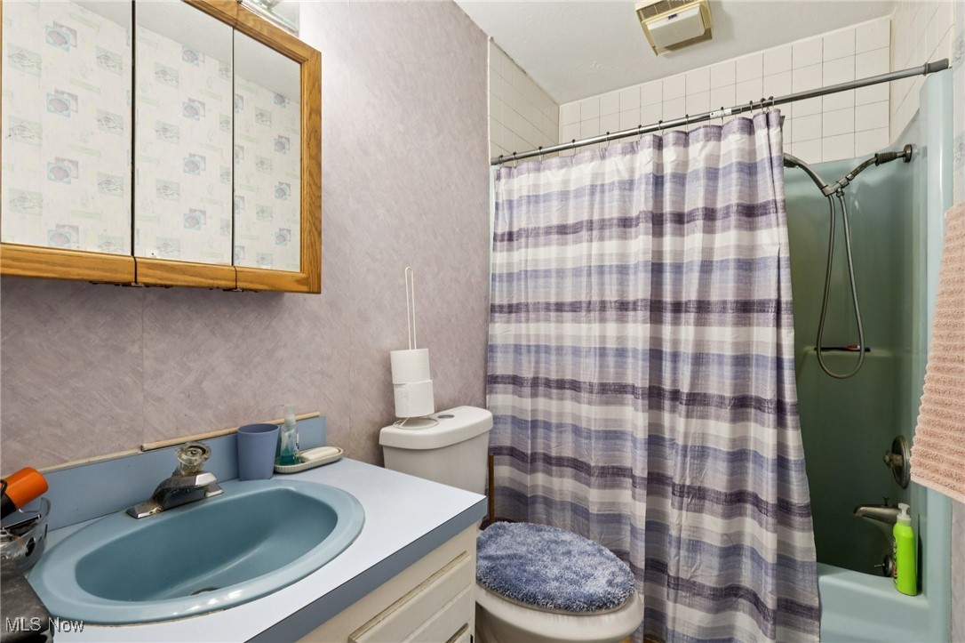 6370 Trumbull Road Geneva, OH 44041 - Photo 20 of 50 Bathroom featuring vanity and shower / bath combo with shower curtain