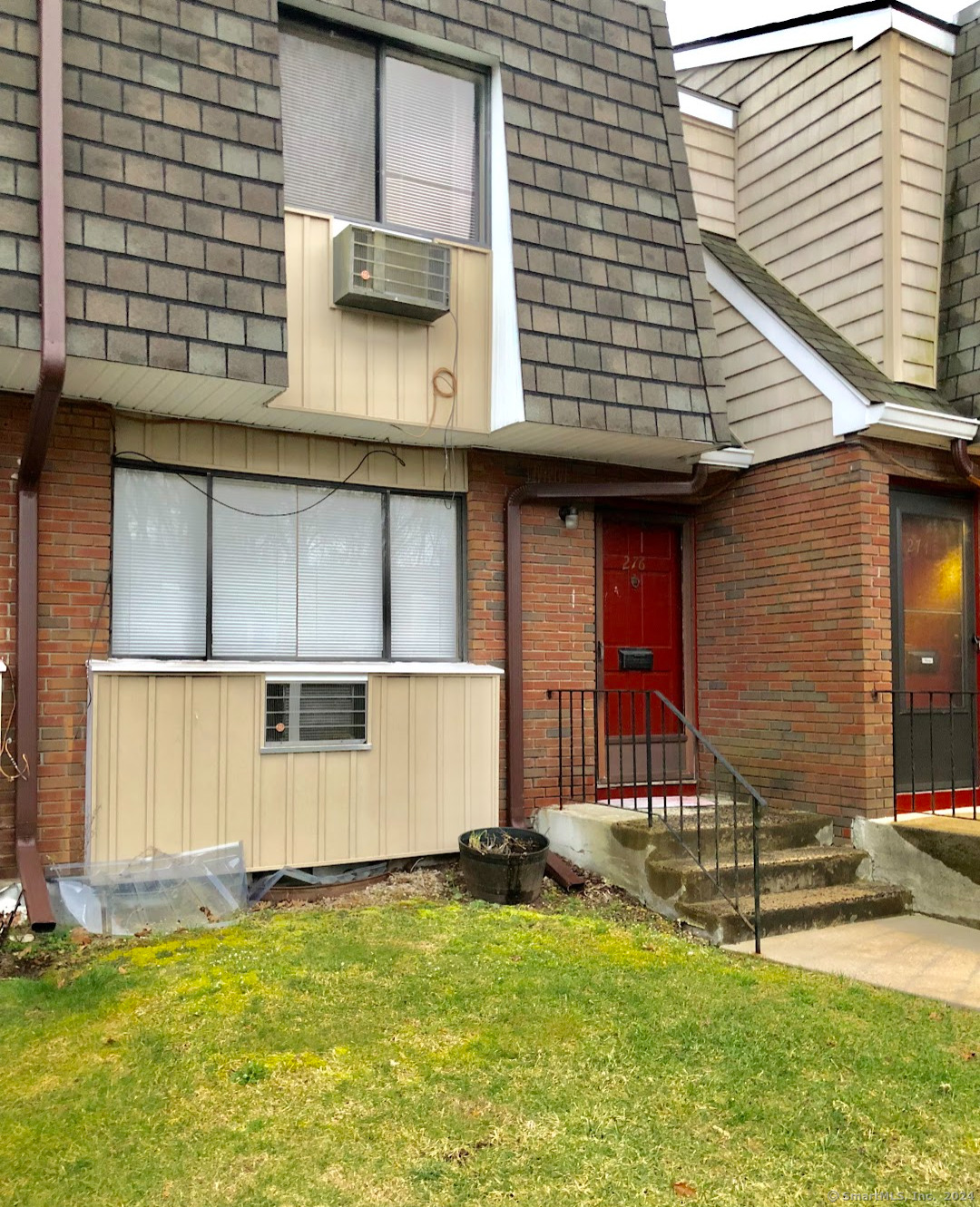 a view of a house with a yard and sitting area
