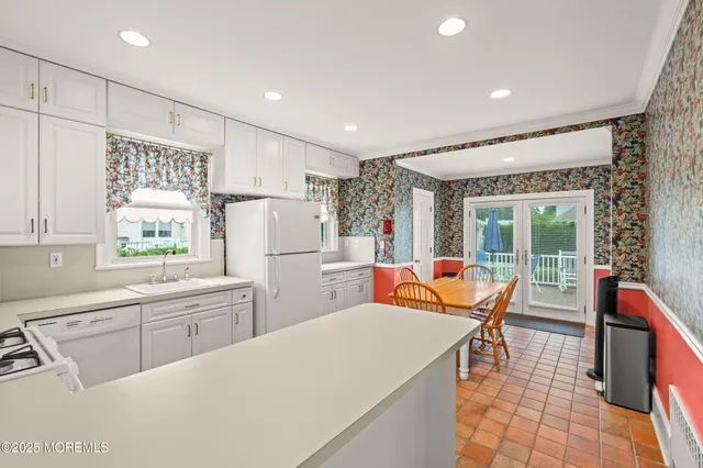 a open kitchen with stainless steel appliances granite countertop a refrigerator and a sink