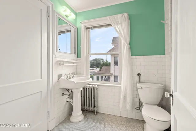 a bathroom with a toilet sink and mirror