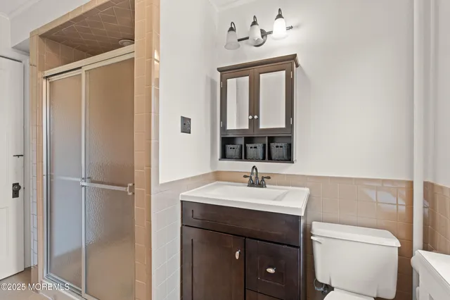 a bathroom with a sink vanity and toilet