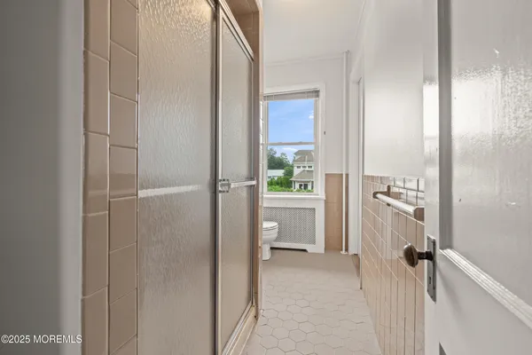 a bathroom with a shower and a sink