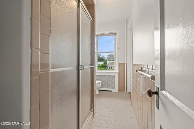 a bathroom with a shower and a sink