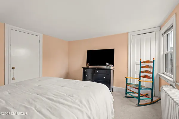 a bedroom with a bed and a television