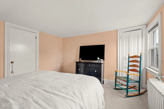 a bedroom with a bed and a television