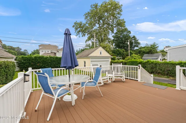 a view of a roof deck with chair and wooden floor