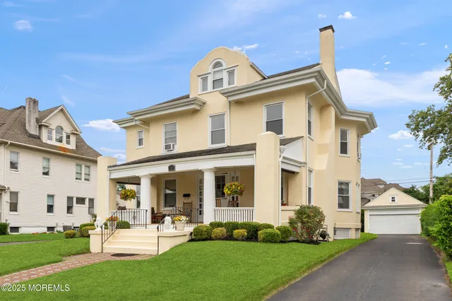a front view of a house with a garden and plants