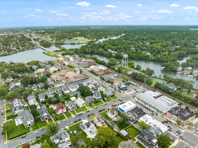an aerial view of residential houses with lake and city view