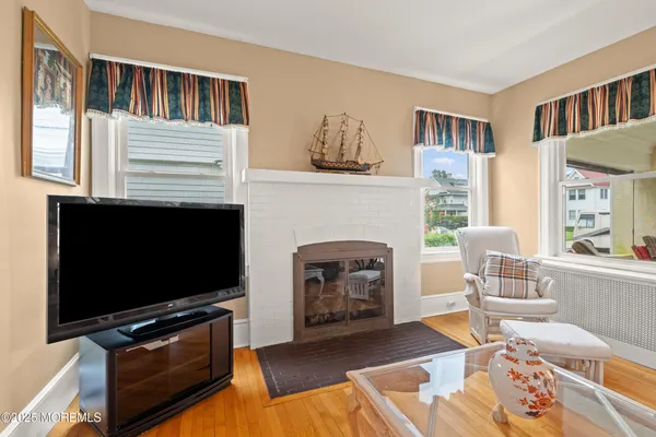 a living room with furniture a flat screen tv and a fireplace