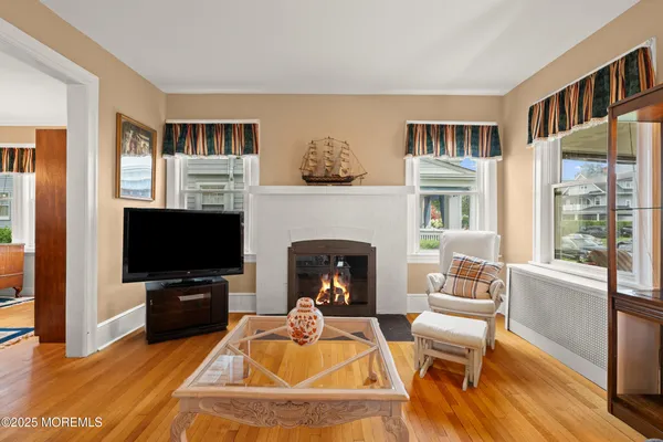 a living room with furniture a fireplace and a flat screen tv