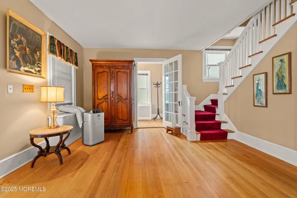 a view of a livingroom with furniture and hardwood floor