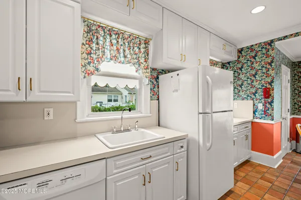 a kitchen with a refrigerator and a sink