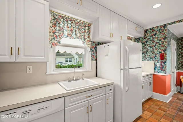 a kitchen with a refrigerator and a sink