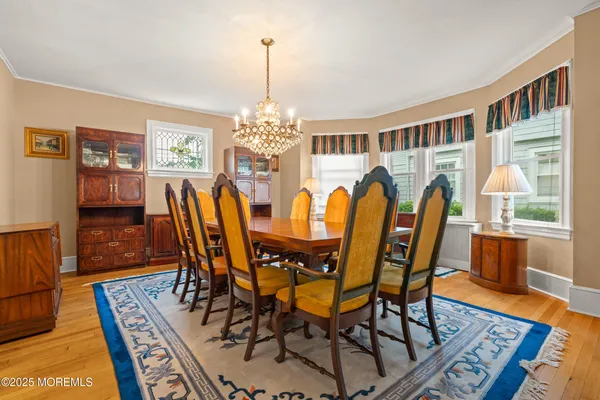 a view of a dining room with furniture wooden floor and chandelier