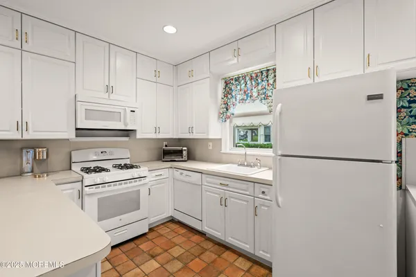 a white refrigerator freezer sitting inside of a kitchen