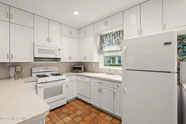 a white refrigerator freezer sitting inside of a kitchen